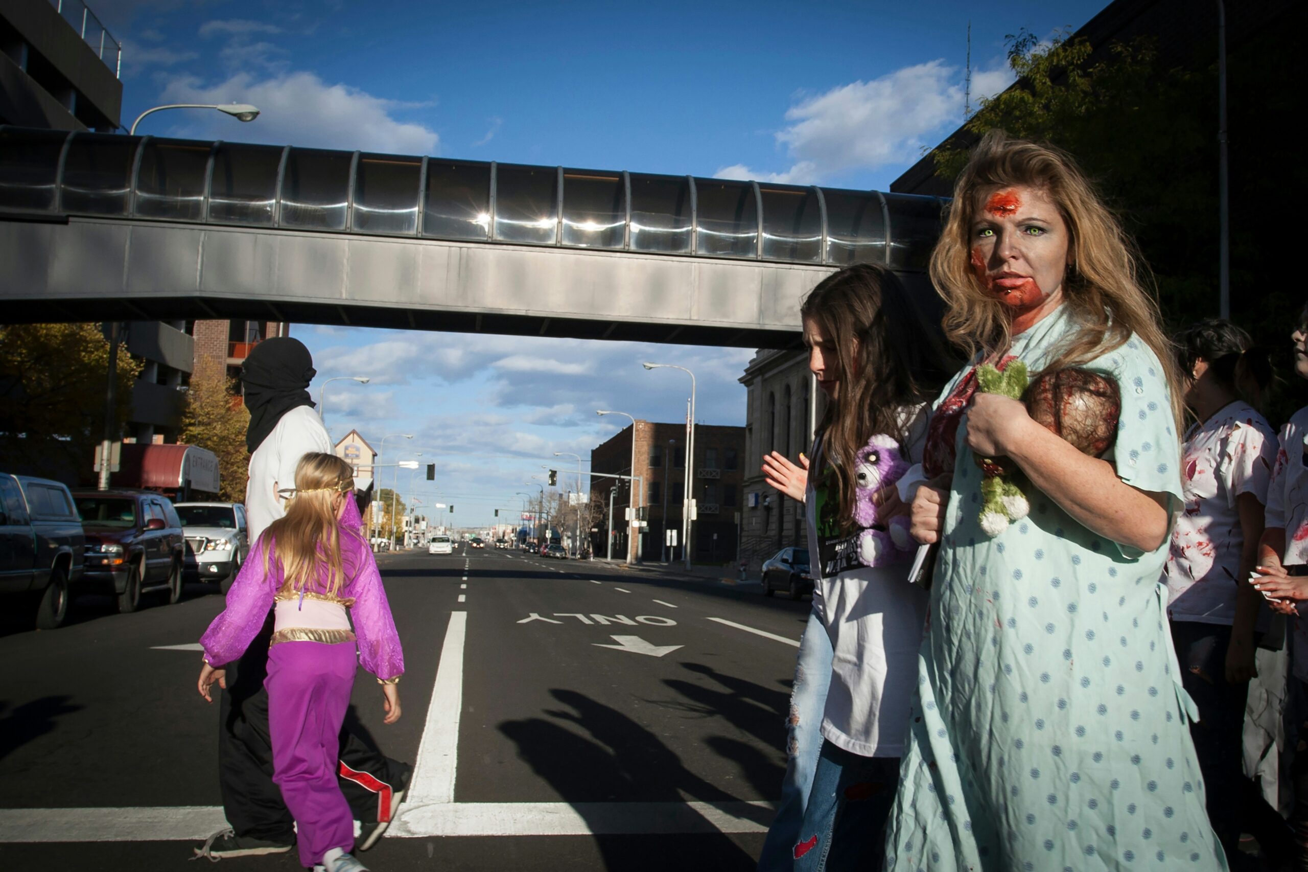 2 women standing on gray concrete road during daytime